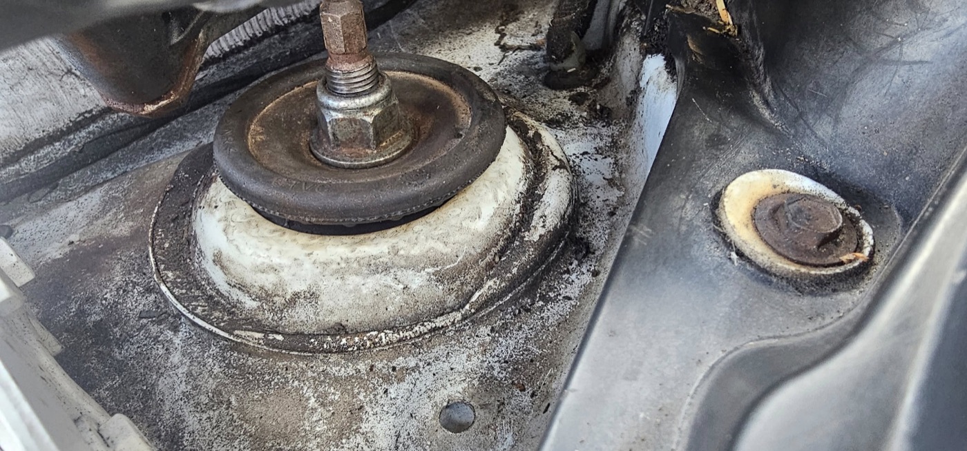 A front strut top mount on an actual Corsa
