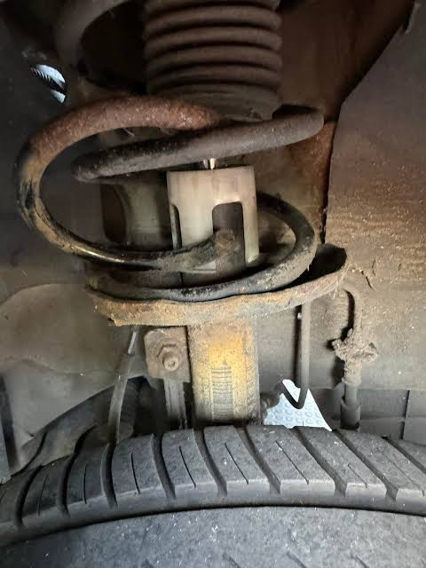 A corroded, snapped coil spring