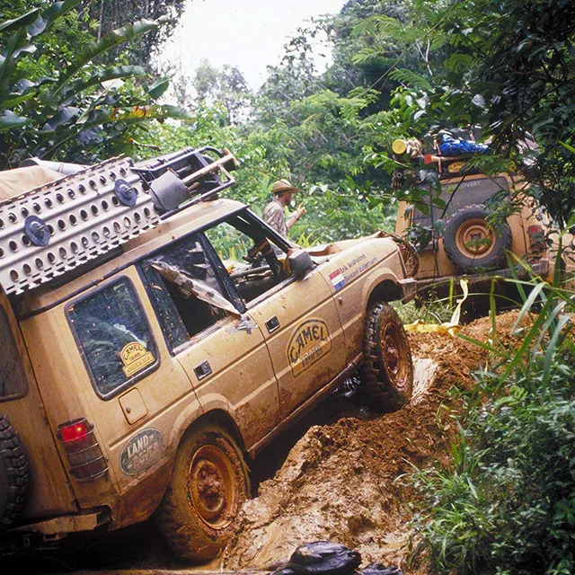 A Camel Trophy vehicle winching through deep mud
